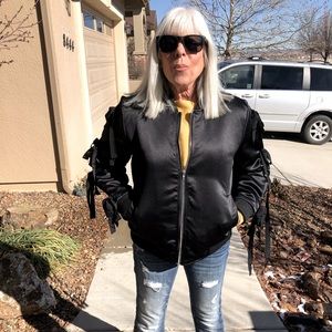Black sateen bomber jacket with bow tie sleeves